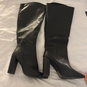 Below the knee black heeled boots